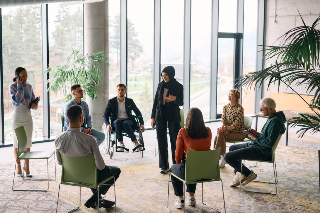 Corporate business team meeting with a manager or coach. Group of happy diverse, multiracial people